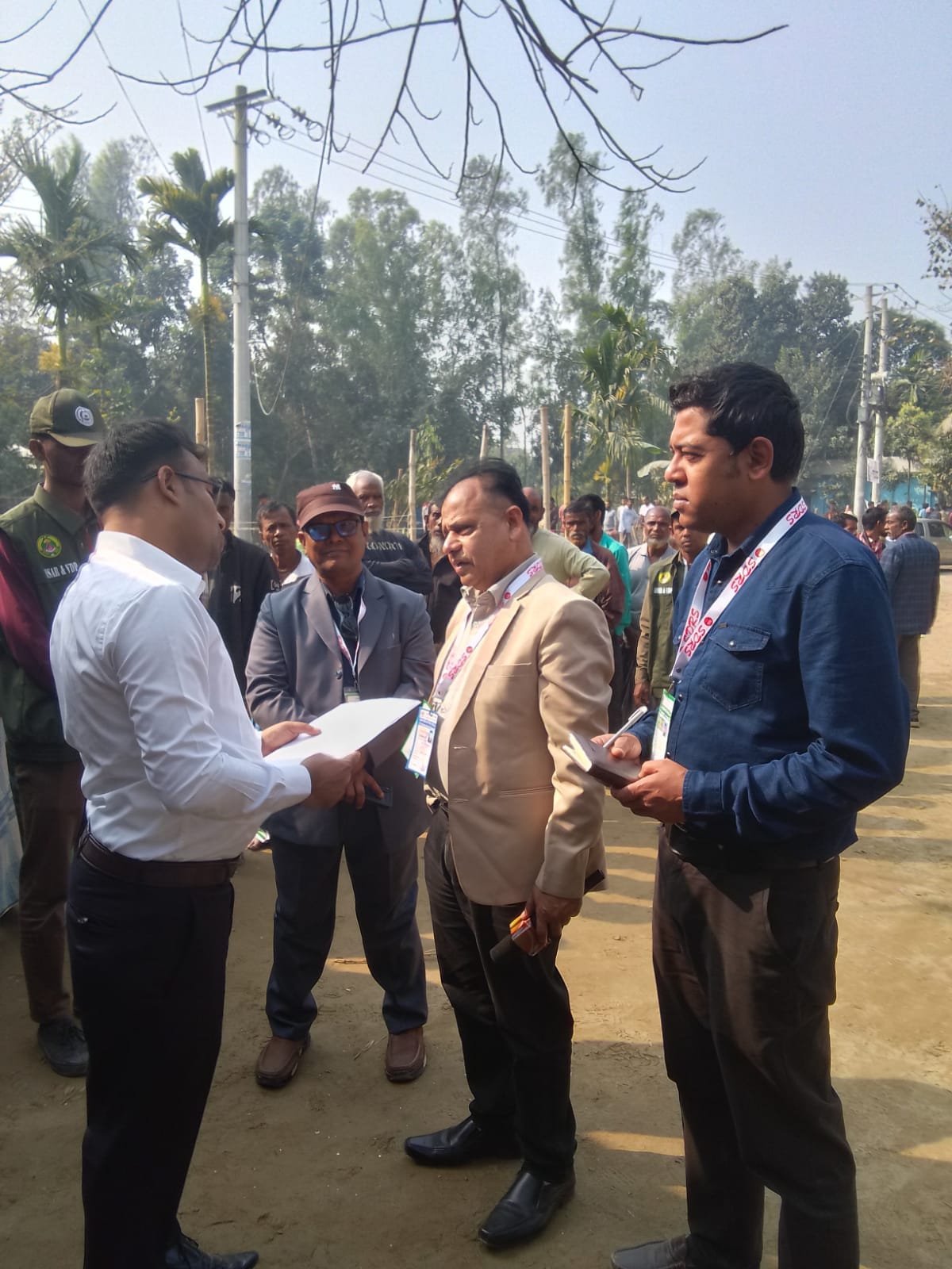 Officials talking at a field event.